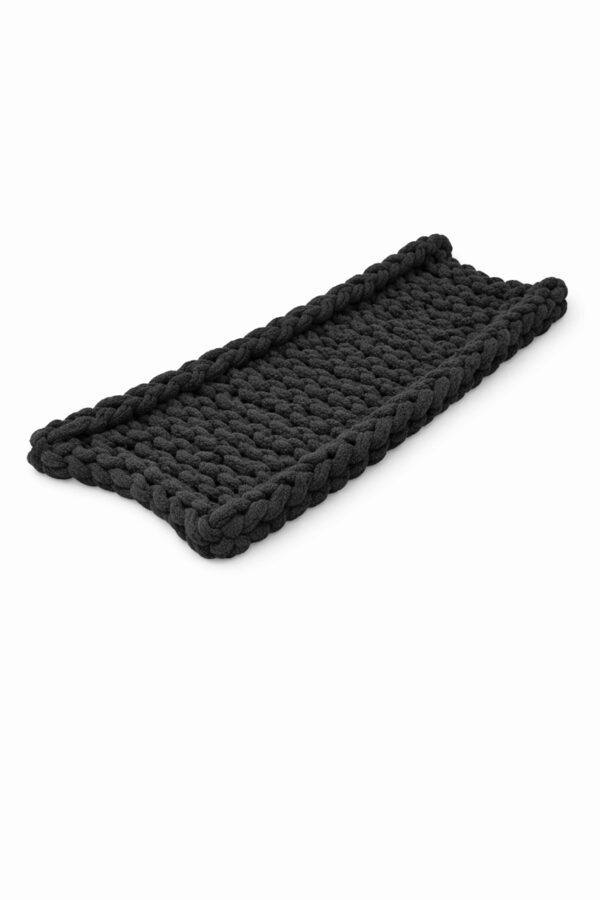Handwoven black wicker tray with raised edges.